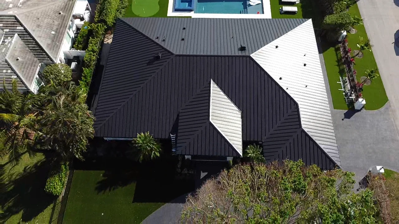 Aerial view of a metal roof with multiple hips, valleys and intersecting roof sections.