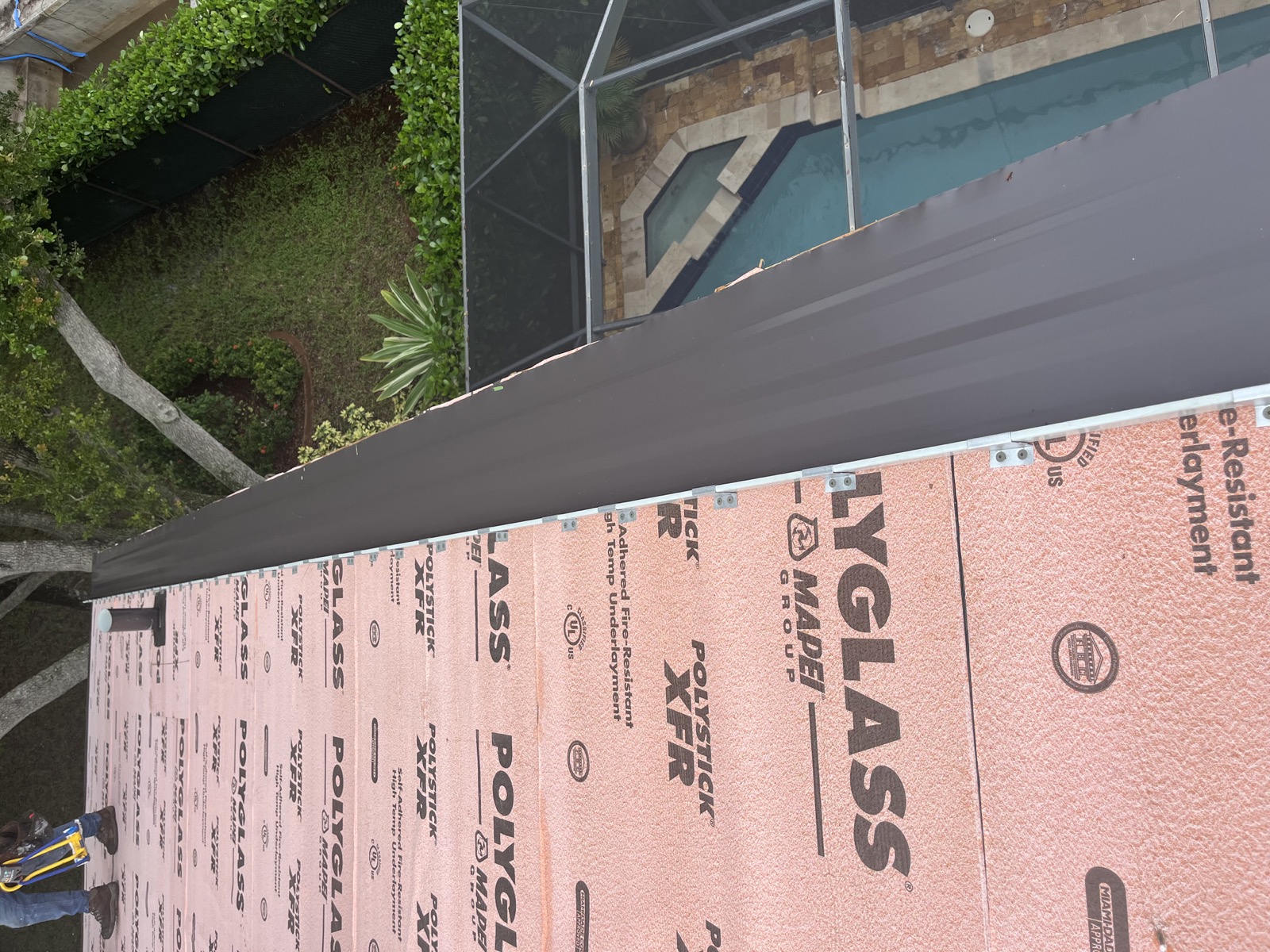Dark Bronze metal panel beside exposed Polystick XFR underlayment during the Coconut Creek project