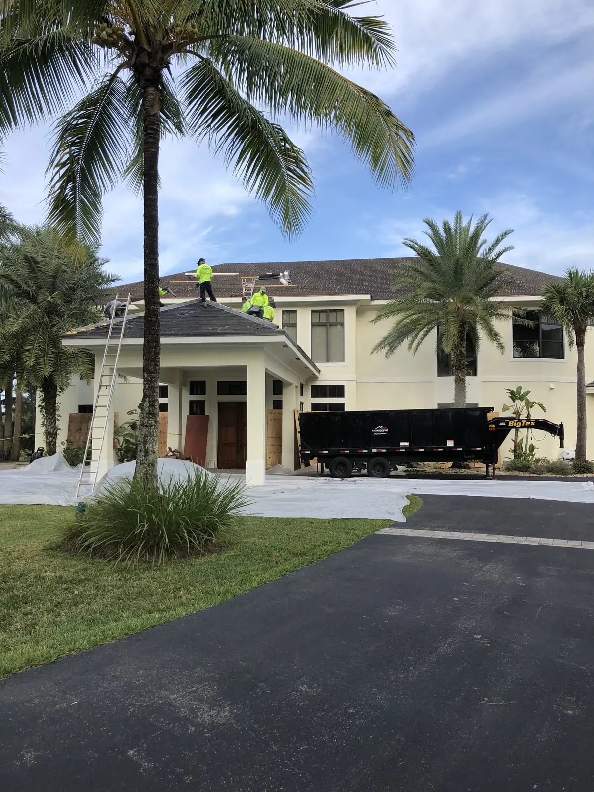 Front view of a large tile-roof home documented before roofing work.
