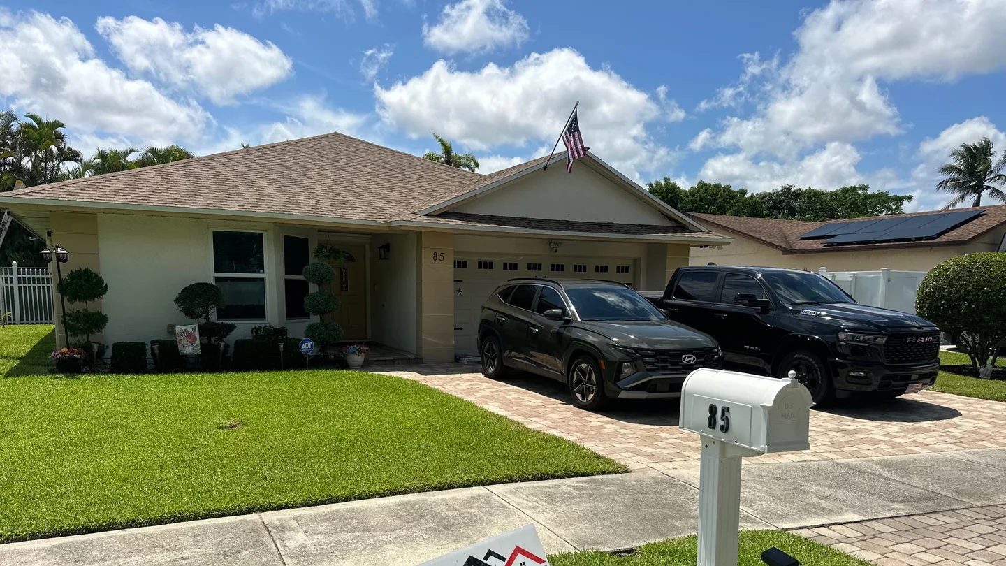 Tan shingle roof over a single-story home with a front-facing garage and gable.