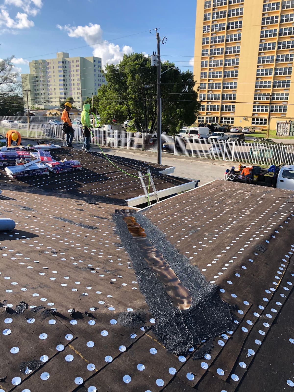 Number 30 felt underlayment and metal-lined roof valley during an asphalt shingle replacement in South Florida.