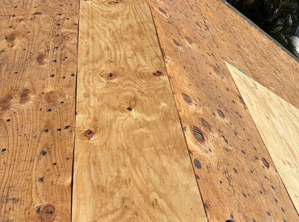 New plywood patches installed in an existing roof deck during a Miramar tile reroof