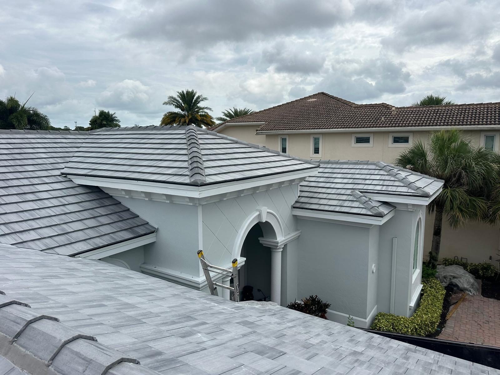 Finished Saxony 900 Slate flat-profile concrete tile roof on a South Florida home in an M&M Roofing jobsite photo.