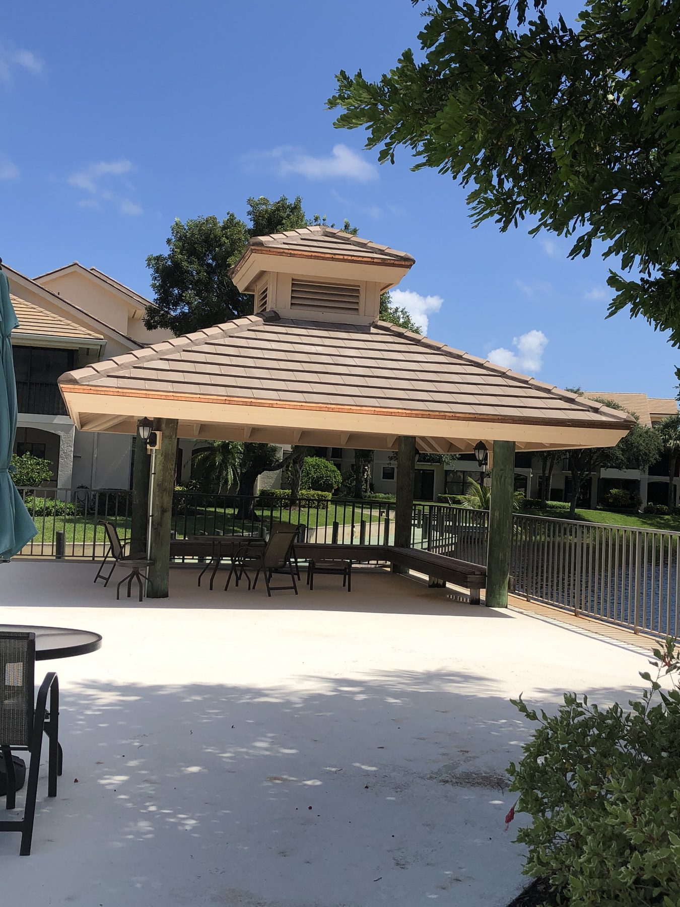 Tan flat-profile Saxony 900 Slate concrete tile installed on a pavilion roof.