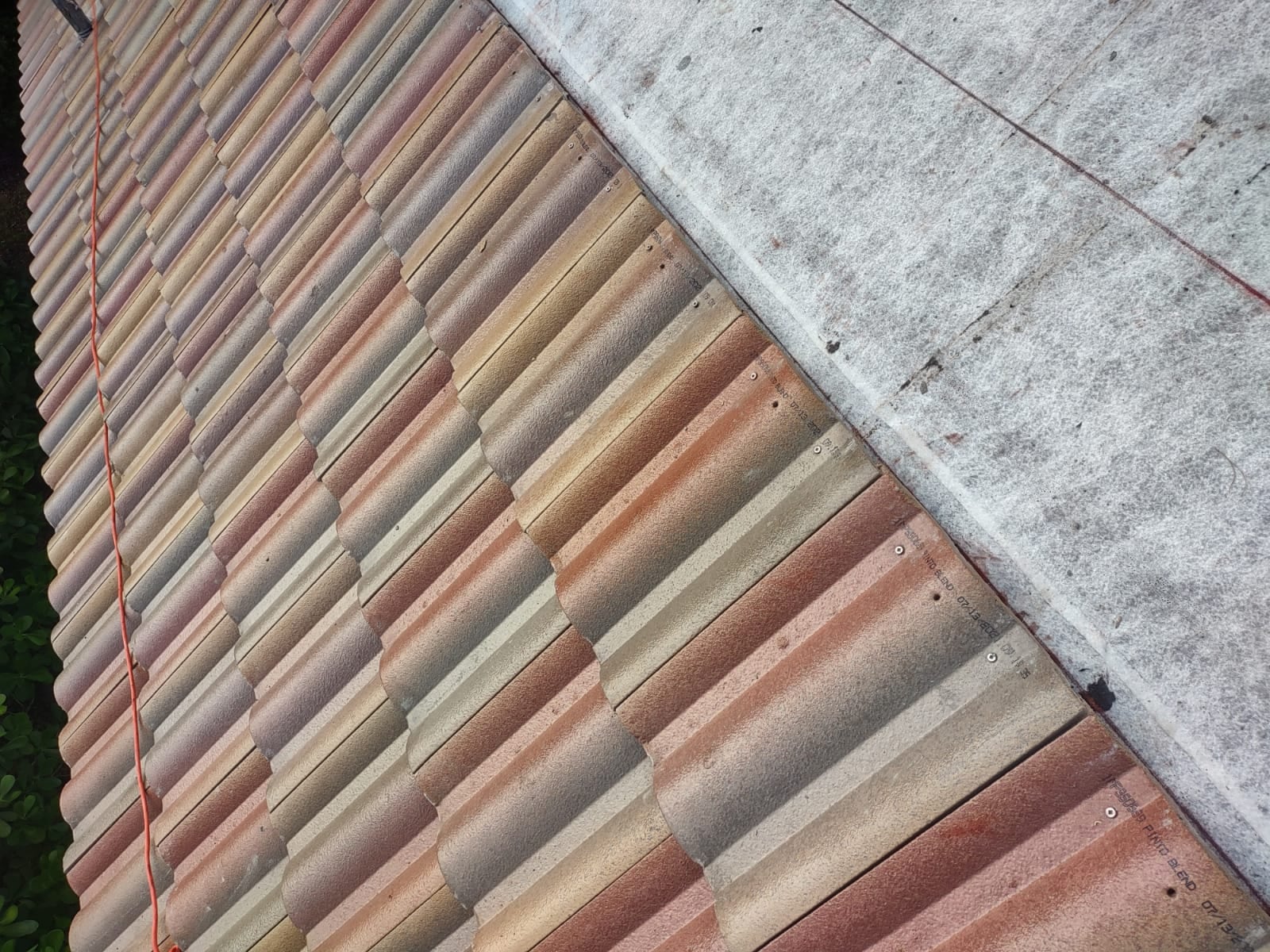 Close view of blended Villa 900 concrete tile courses beside exposed underlayment during a South Florida roof installation.