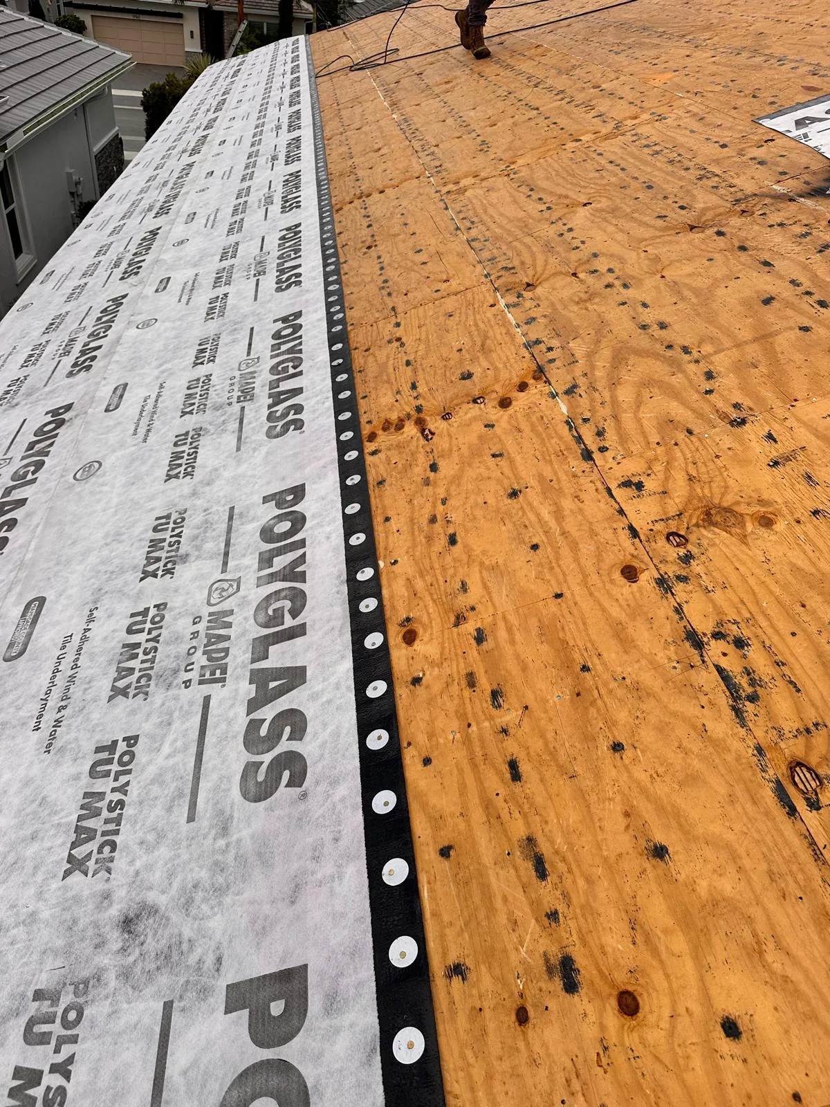 Polyglass Polystick TU MAX underlayment across a roof during a West Palm Beach tile-to-tile reroof